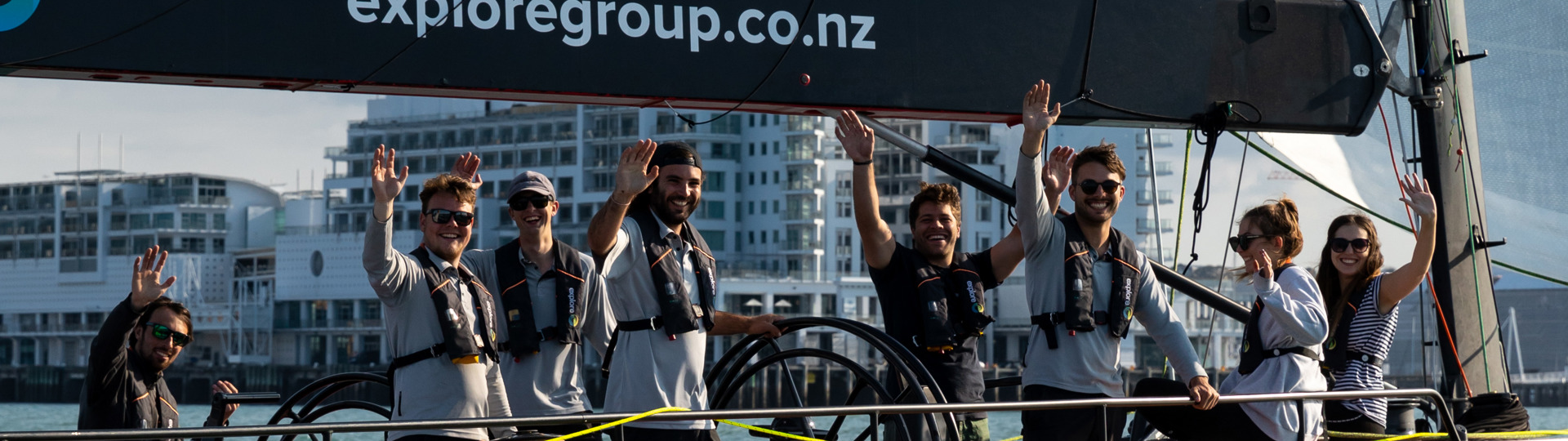 friendly Explore crew and passengers on an America's Cup Sailing yacht